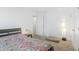 Bright bedroom with a patterned bedspread, a standing lamp, and access to a closet and a door at 12223 Split Granite Dr, Fishers, IN 46037