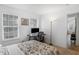 Bedroom with neutral walls, large window, colorful bedspread, and office area at 12223 Split Granite Dr, Fishers, IN 46037