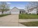 Charming single-story home with a two-car garage, landscaped front yard, and inviting front porch at 12223 Split Granite Dr, Fishers, IN 46037