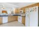 Bright kitchen features wood cabinets, neutral backsplash, blue countertops and white appliances at 12223 Split Granite Dr, Fishers, IN 46037