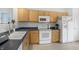 Bright kitchen features wood cabinets, neutral backsplash, blue countertops and white appliances at 12223 Split Granite Dr, Fishers, IN 46037
