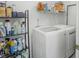 A well-equipped laundry room offers convenience and storage with shelving and side by side washer and dryer at 12223 Split Granite Dr, Fishers, IN 46037