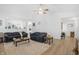 Spacious living room with a high ceiling, ceiling fan, hardwood floors and two couches at 12223 Split Granite Dr, Fishers, IN 46037