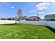 Large fenced backyard with green grass and young trees at 1291 Timber Bluff Rd, Westfield, IN 46074