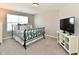 Bedroom featuring a bed with a patterned comforter, window, and a TV at 1291 Timber Bluff Rd, Westfield, IN 46074