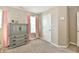 Neutral bedroom featuring a dresser, light-filled window, and pink curtains at 1291 Timber Bluff Rd, Westfield, IN 46074