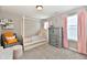 Bright bedroom featuring a four-poster bed, a cozy chair, and soft pink accents at 1291 Timber Bluff Rd, Westfield, IN 46074