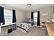 Cozy bedroom with patterned bedding, window, and colorful books at 1291 Timber Bluff Rd, Westfield, IN 46074