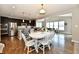 Bright and spacious dining area with a large table, stainless steel appliances, and hardwood floors at 1291 Timber Bluff Rd, Westfield, IN 46074