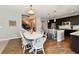 Open-concept dining area with a white table, stylish chairs, and modern lighting fixtures at 1291 Timber Bluff Rd, Westfield, IN 46074