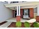 Inviting front porch featuring a cozy seating area, brick pillars, and well-maintained landscaping at 1291 Timber Bluff Rd, Westfield, IN 46074