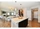 Open concept kitchen features a granite island with pendant lighting and flows into the dining and living areas at 1291 Timber Bluff Rd, Westfield, IN 46074