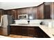Kitchen showcases stainless steel appliances, dark wood cabinetry, granite countertops, and hardwood flooring at 1291 Timber Bluff Rd, Westfield, IN 46074