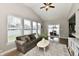 The living room features hardwood floors, lots of natural light, and a comfortable seating area with sliders to the patio at 1291 Timber Bluff Rd, Westfield, IN 46074