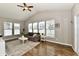 Bright living room with hardwood floors, a ceiling fan, large windows, and comfortable seating at 1291 Timber Bluff Rd, Westfield, IN 46074