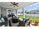 Relaxing covered patio with a ceiling fan, stylish furniture, and a view of the well-maintained backyard at 1291 Timber Bluff Rd, Westfield, IN 46074