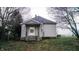 This charming home's front entrance features a cozy, covered porch, perfect for enjoying quiet evenings at 1303 S Shipley St, Muncie, IN 47302