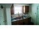 Functional kitchen features wood cabinets, stainless steel sink, and modern appliances at 1303 S Shipley St, Muncie, IN 47302
