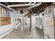 Unfinished basement features concrete floor and walls with visible pipes and utilities at 1417 Sturm Ave, Indianapolis, IN 46201