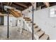 Basement stairs leading up to a door with a laundry machine to the left at 1417 Sturm Ave, Indianapolis, IN 46201
