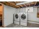 Basement features two washer and dryer units on a concrete floor at 1417 Sturm Ave, Indianapolis, IN 46201
