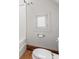Close-up of a toilet next to a tub with a small window at 1417 Sturm Ave, Indianapolis, IN 46201