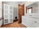 Bathroom showcasing a granite countertop, a modern white cabinet, and a mirror at 1417 Sturm Ave, Indianapolis, IN 46201