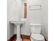 Classic bathroom with pedestal sink, mirror, towel bar and toilet at 1417 Sturm Ave, Indianapolis, IN 46201