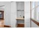 A built-in desk area with white storage cabinets and wood trim at 1417 Sturm Ave, Indianapolis, IN 46201