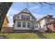 Charming two-story home featuring a peaked roof, light siding, and a well-manicured lawn at 1417 Sturm Ave, Indianapolis, IN 46201