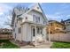 Charming two-story home with white siding, gray shutters and covered porch at 1417 Sturm Ave, Indianapolis, IN 46201