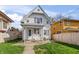 Charming two-story home with white siding, covered porch and green grass at 1417 Sturm Ave, Indianapolis, IN 46201