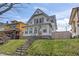 Charming two-story home featuring a peaked roof, light siding, and a well-manicured lawn at 1417 Sturm Ave, Indianapolis, IN 46201