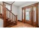 Classic foyer features a wooden staircase and decorative glass paneled doors at 1417 Sturm Ave, Indianapolis, IN 46201