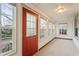 Sunlit front porch offering a welcoming entrance with multiple windows at 1417 Sturm Ave, Indianapolis, IN 46201