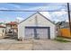 Detached garage with gray doors and white siding, providing ample parking and storage space at 1417 Sturm Ave, Indianapolis, IN 46201