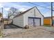 Detached garage with concrete driveway and a gray garage door at 1417 Sturm Ave, Indianapolis, IN 46201
