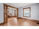 Inviting living room features wood trim, large window, and hardwood floors at 1417 Sturm Ave, Indianapolis, IN 46201