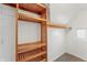 Bright walk-in closet featuring a wooden closet system and a small window providing natural light at 1417 Sturm Ave, Indianapolis, IN 46201