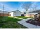 Large backyard with walkway, grass, and detached garage at 1603 E Market St, Indianapolis, IN 46201
