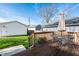 Outdoor deck with table and chairs, green lawn, detached garages, and privacy fence at 1603 E Market St, Indianapolis, IN 46201
