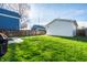 View of backyard with grill and detached garage; a blue house also visible at 1603 E Market St, Indianapolis, IN 46201