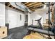 Basement gym featuring modern treadmill, squat rack, and exposed ductwork at 1603 E Market St, Indianapolis, IN 46201