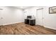 Unfinished basement with vinyl wood flooring features open space and three doors at 1603 E Market St, Indianapolis, IN 46201