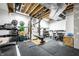 Spacious basement gym with workout equipment, rubber flooring, and exposed ceilings at 1603 E Market St, Indianapolis, IN 46201