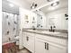 Updated bathroom with double sink vanity, granite countertops, and mermaid-themed shower curtain at 1603 E Market St, Indianapolis, IN 46201