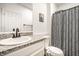 Cozy bathroom featuring a granite countertop, modern fixtures, and a patterned shower curtain at 1603 E Market St, Indianapolis, IN 46201