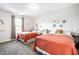 Bedroom with carpet, natural light, two beds with orange comforters, and decorations on the walls at 1603 E Market St, Indianapolis, IN 46201