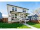 Inviting two-story home boasting an open front porch, lush green lawn, and delightful curb appeal at 1603 E Market St, Indianapolis, IN 46201