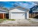Detached garage with a white door and siding, surrounded by gravel at 1603 E Market St, Indianapolis, IN 46201
